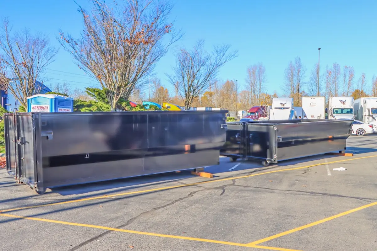 Professional dumpster rental service with roll-off container on residential driveway in Douglas